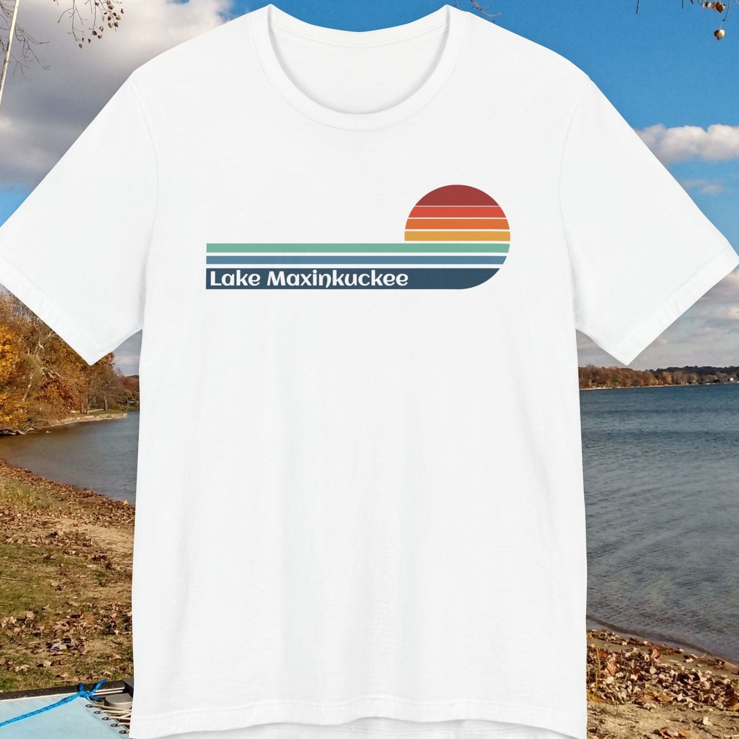 White t-shirt with 'Lake Maxinkuckee' design on a scenic lake background