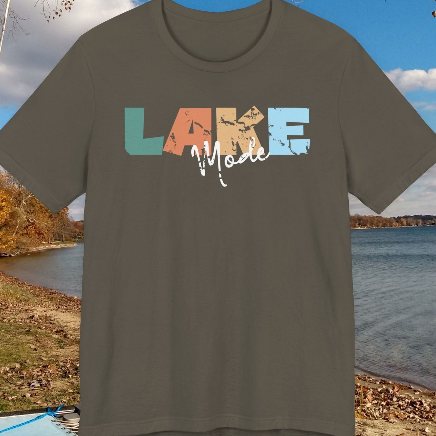 t-shirt with 'LAKE' design in colorful letters against a lakeside background