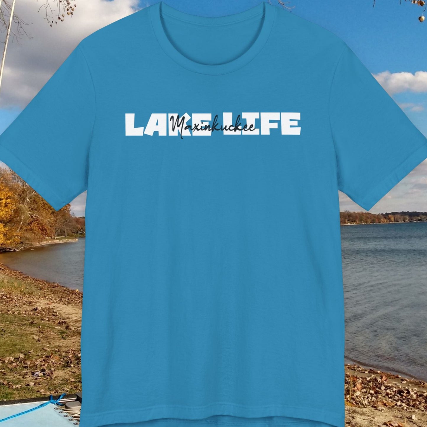 Blue t-shirt with 'Lake Life' text on a lakeside background
