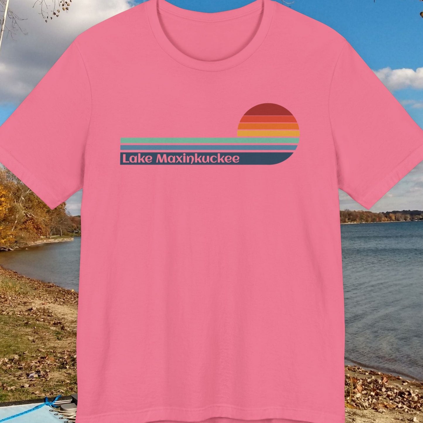 Pink t-shirt with 'Lake Maxinkuckee' design on a lakeside background