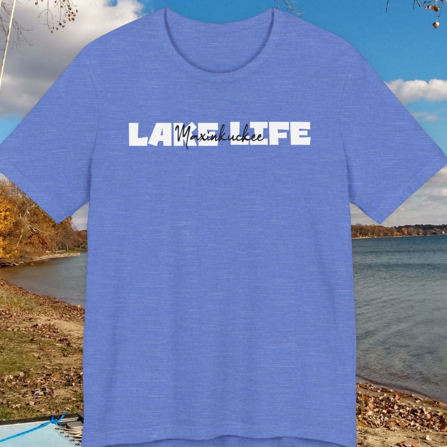 Blue t-shirt with 'Lake Life' text against a scenic lake background