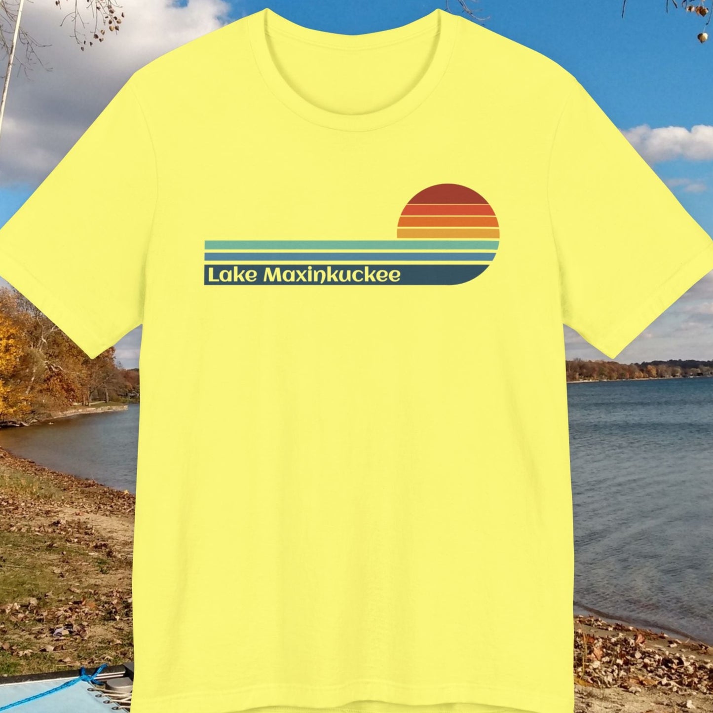 Yellow t-shirt with 'Lake Maxinkuckee' design on a lakeside background