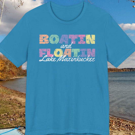 Blue t-shirt with colorful text on a lake shore background