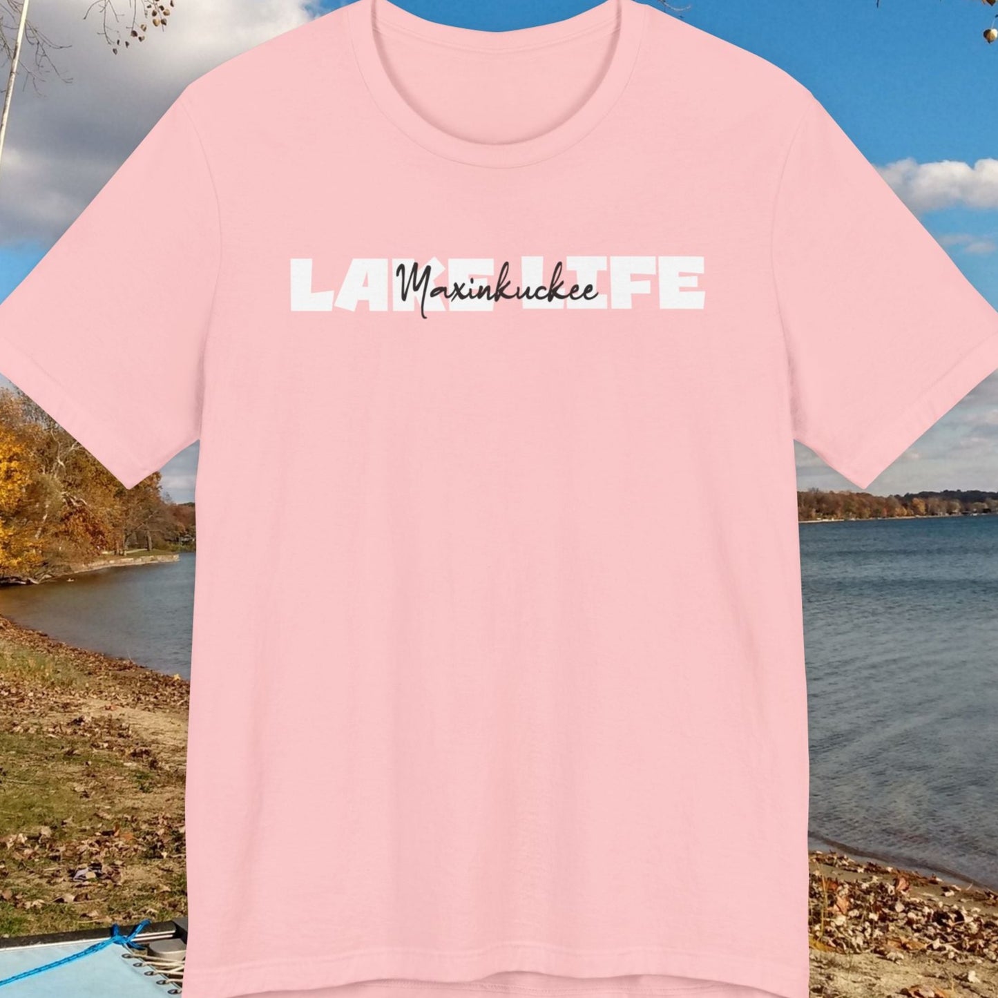 Pink t-shirt with text on a lakeside background
