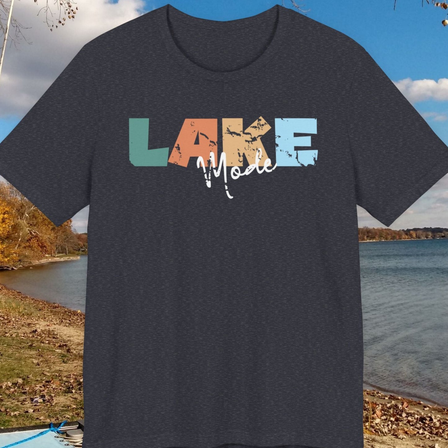 Black t-shirt with 'LAKE' design on a lakeside background