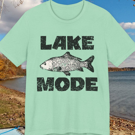 Light green t-shirt with 'Lake Mode' and fish graphic on a lakeside background
