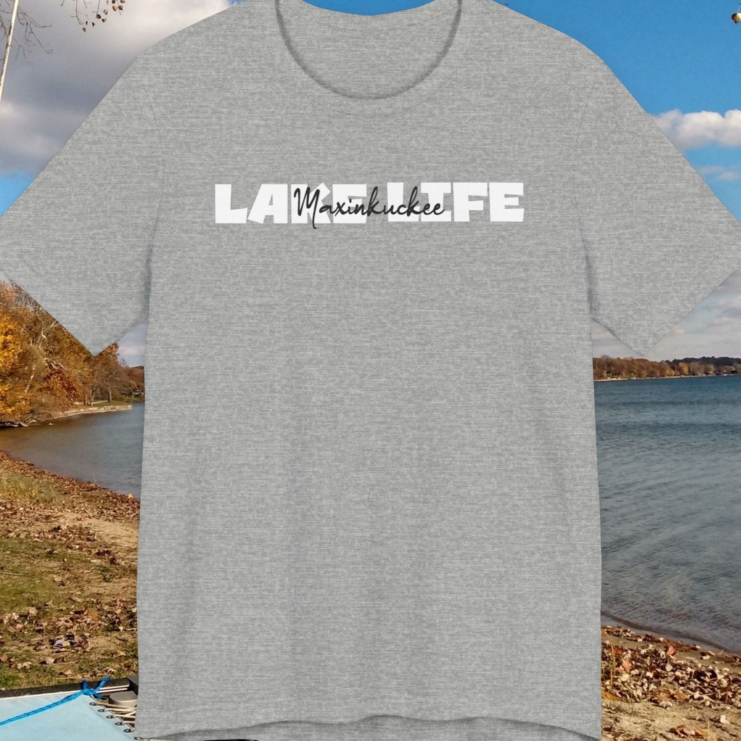 Gray t-shirt with 'Lake Life' text against a scenic lake background
