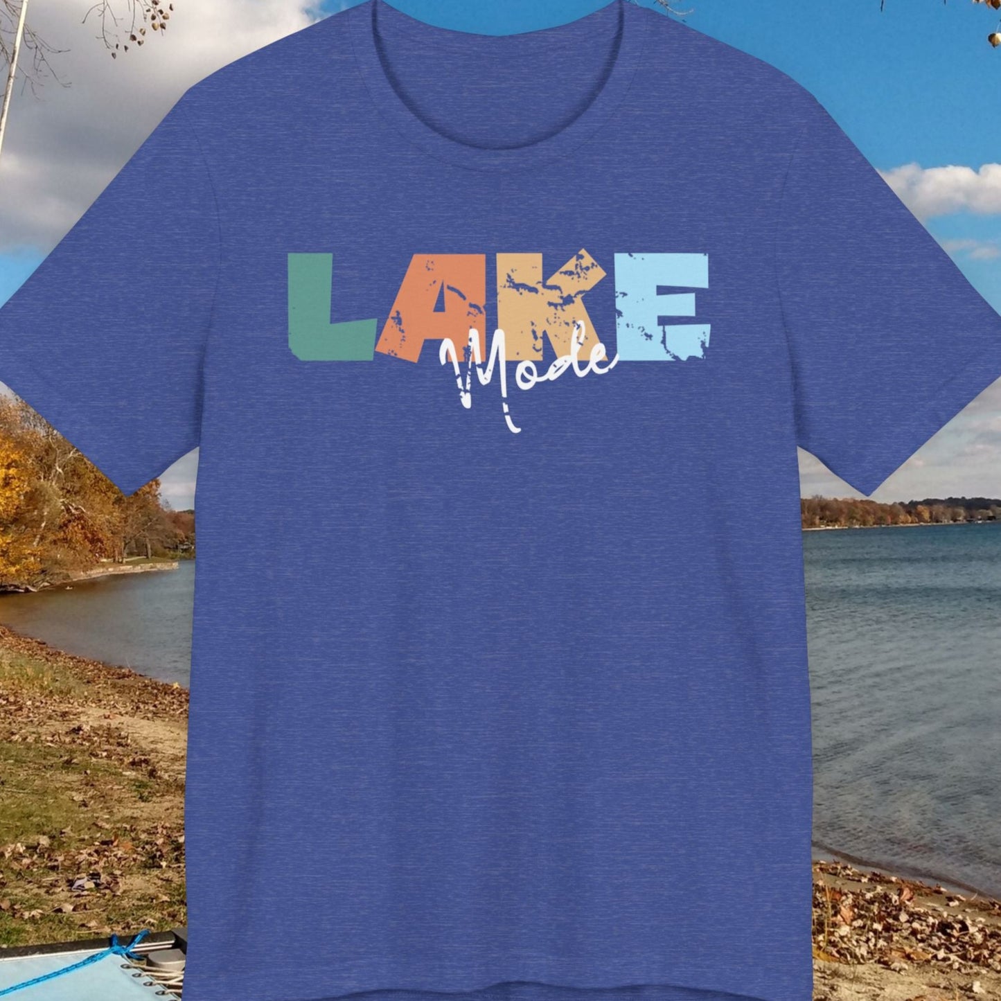 Blue t-shirt with 'LAKE' design against a lakeside background