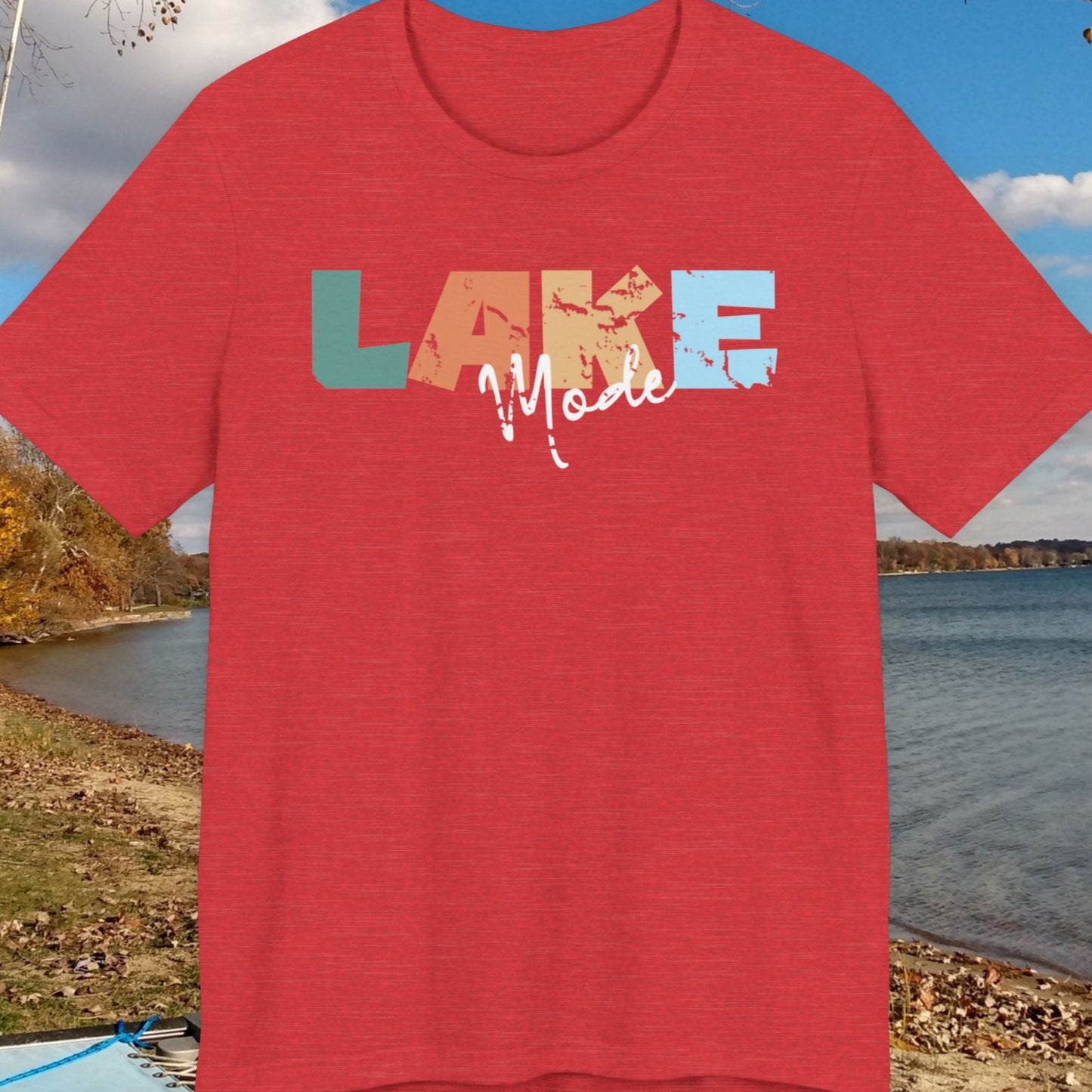 Red t-shirt with 'LAKE MOORE' design on a lakeside background