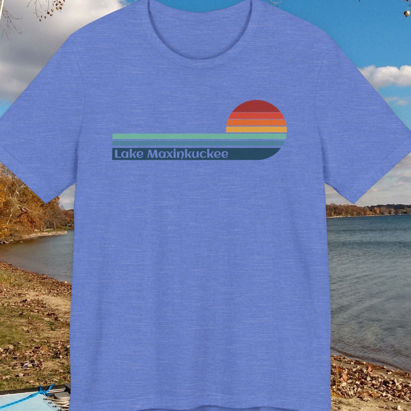 Blue t-shirt with a colorful graphic design on a beach background