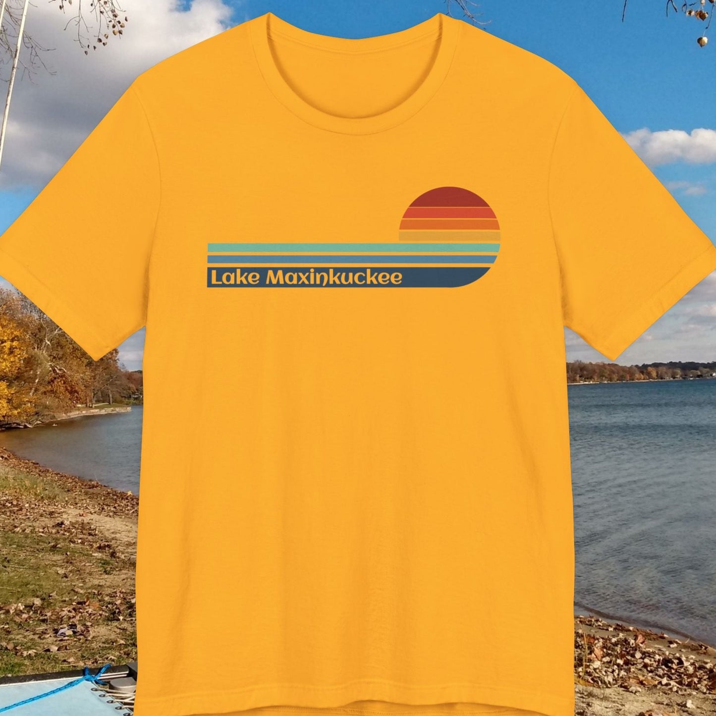 Yellow t-shirt with 'Lake Maxinkuckee' design on a lakeside background