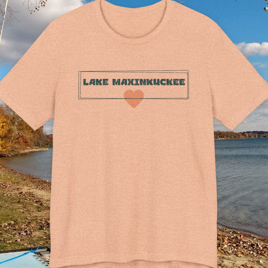 Beige t-shirt with 'Lake Maxinkuckee' text and heart graphic on a lakeside background
