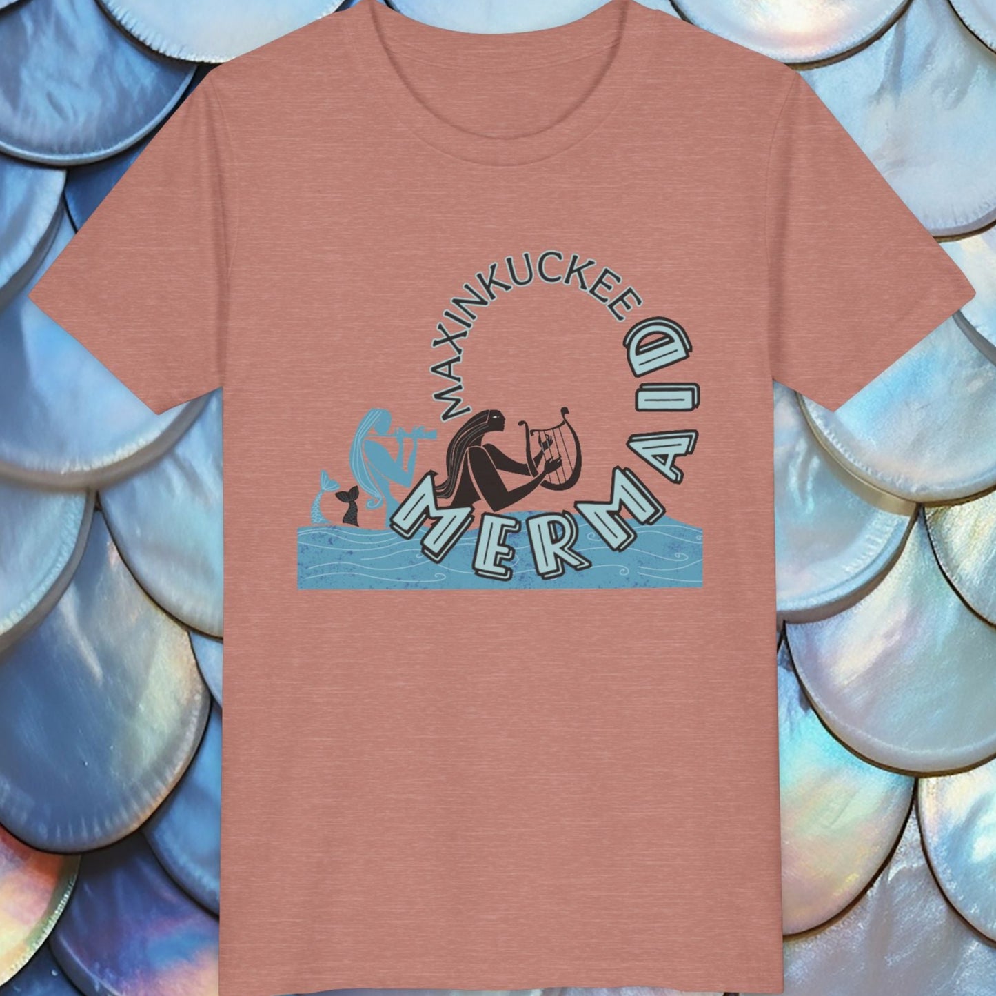 heather peach t-shirt with 'Maxinkuckee Mermaid' design on a background of blue and silver fish scales.