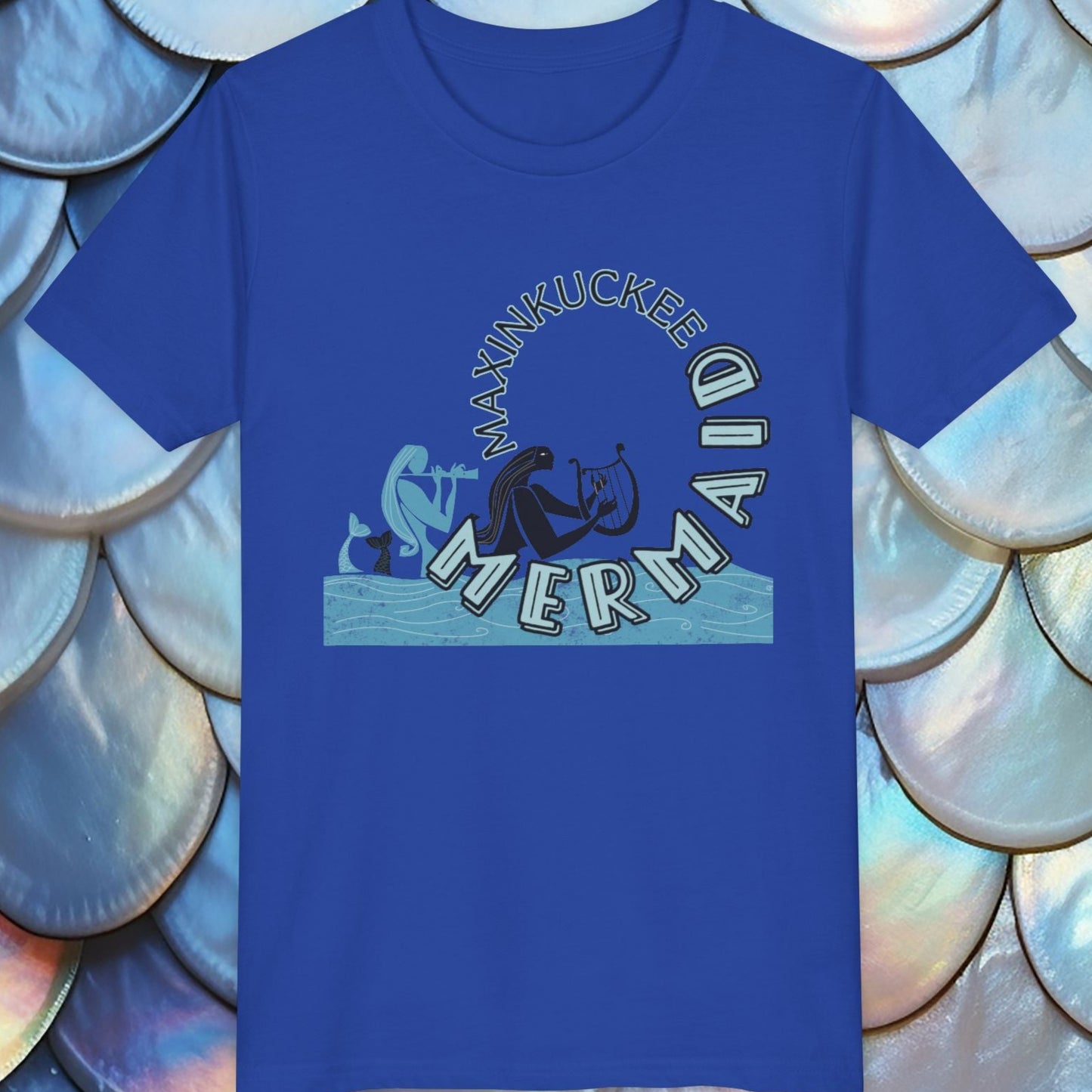 Blue t-shirt with 'Manhukkee Mermaid' design on a shell-patterned background