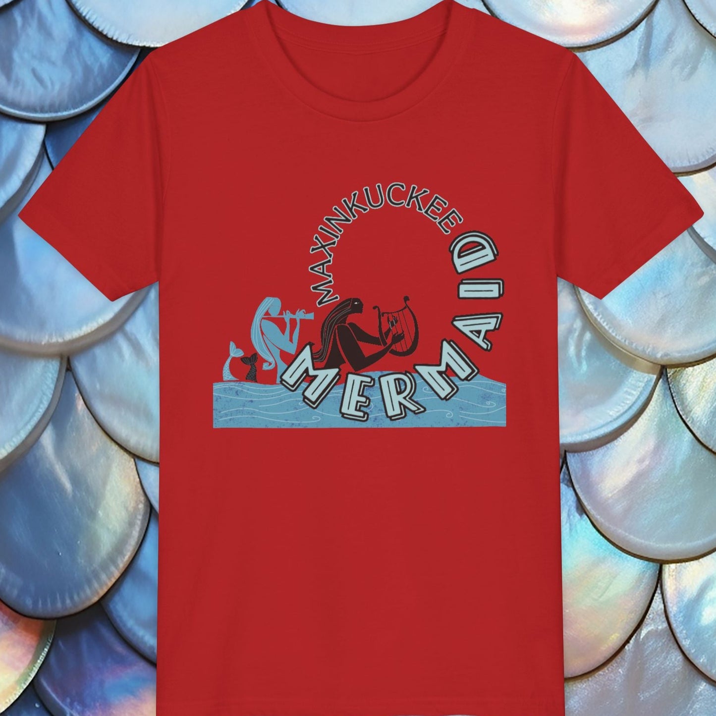 Red t-shirt with mermaid graphic on a textured blue and white background