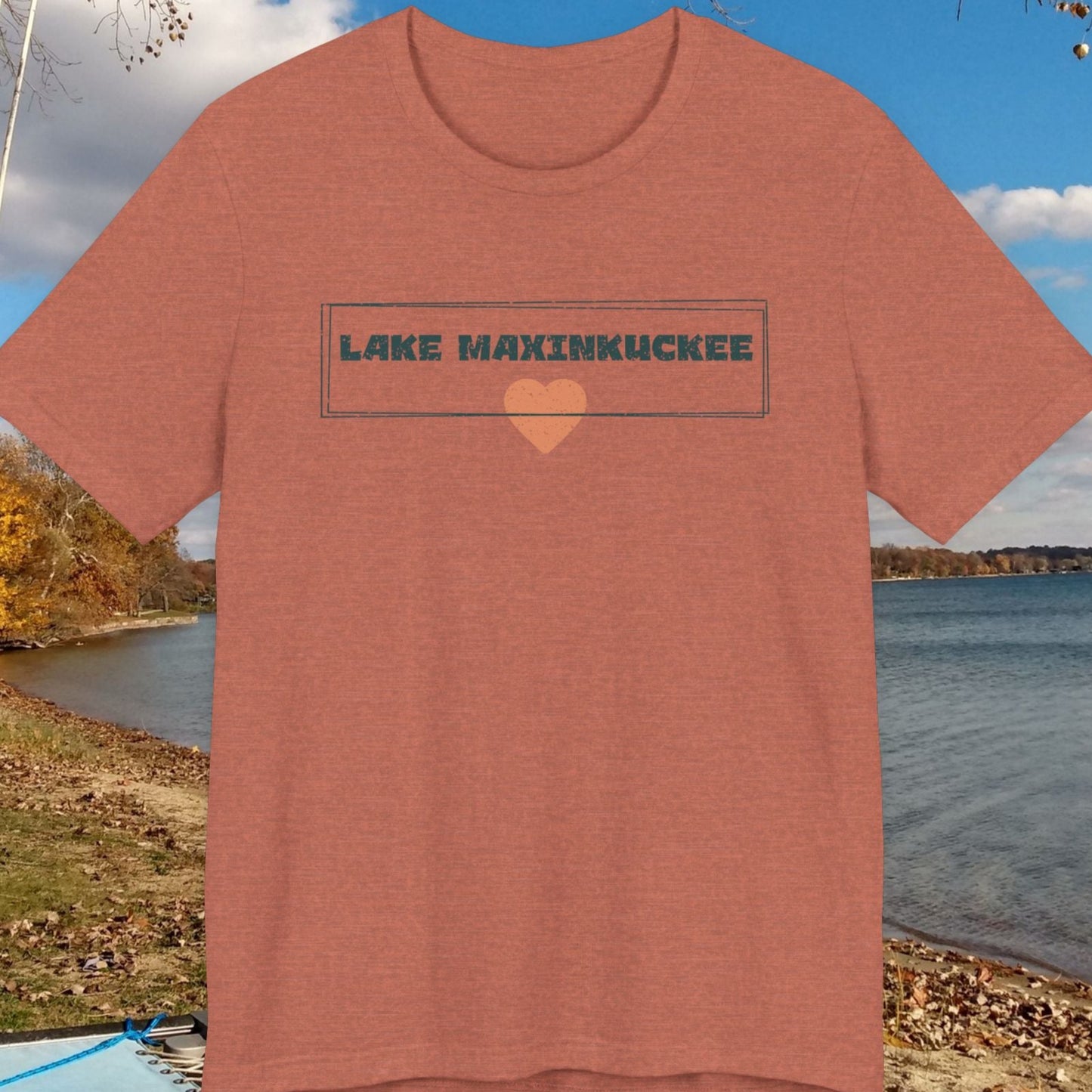 Red t-shirt with 'Lake Maxinkuckee' text against a lakeside background