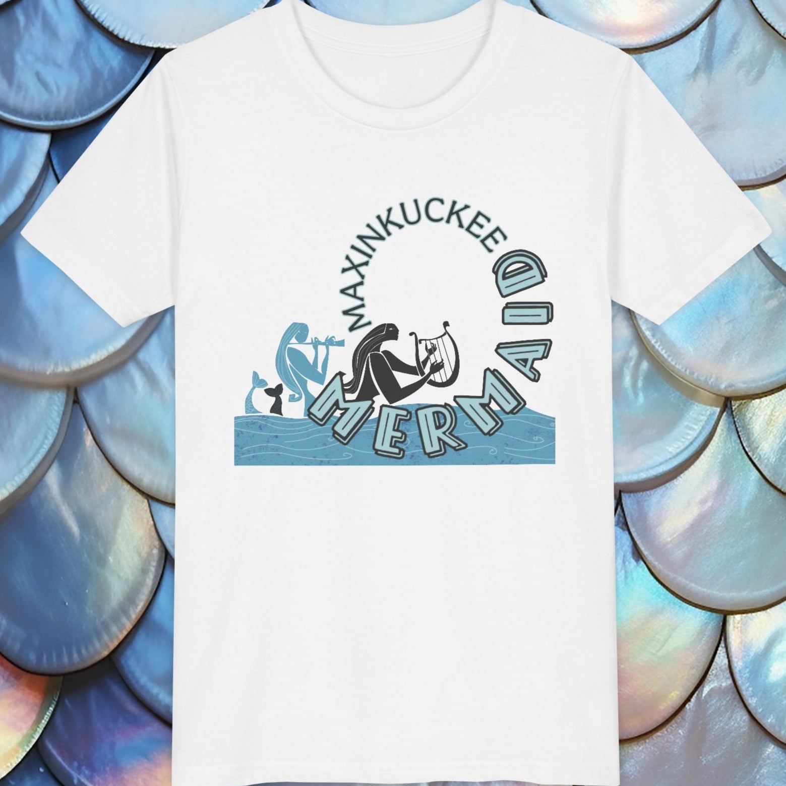 White t-shirt with 'Maxinkuckee Mermaid' design on a background of blue and silver fish scales.