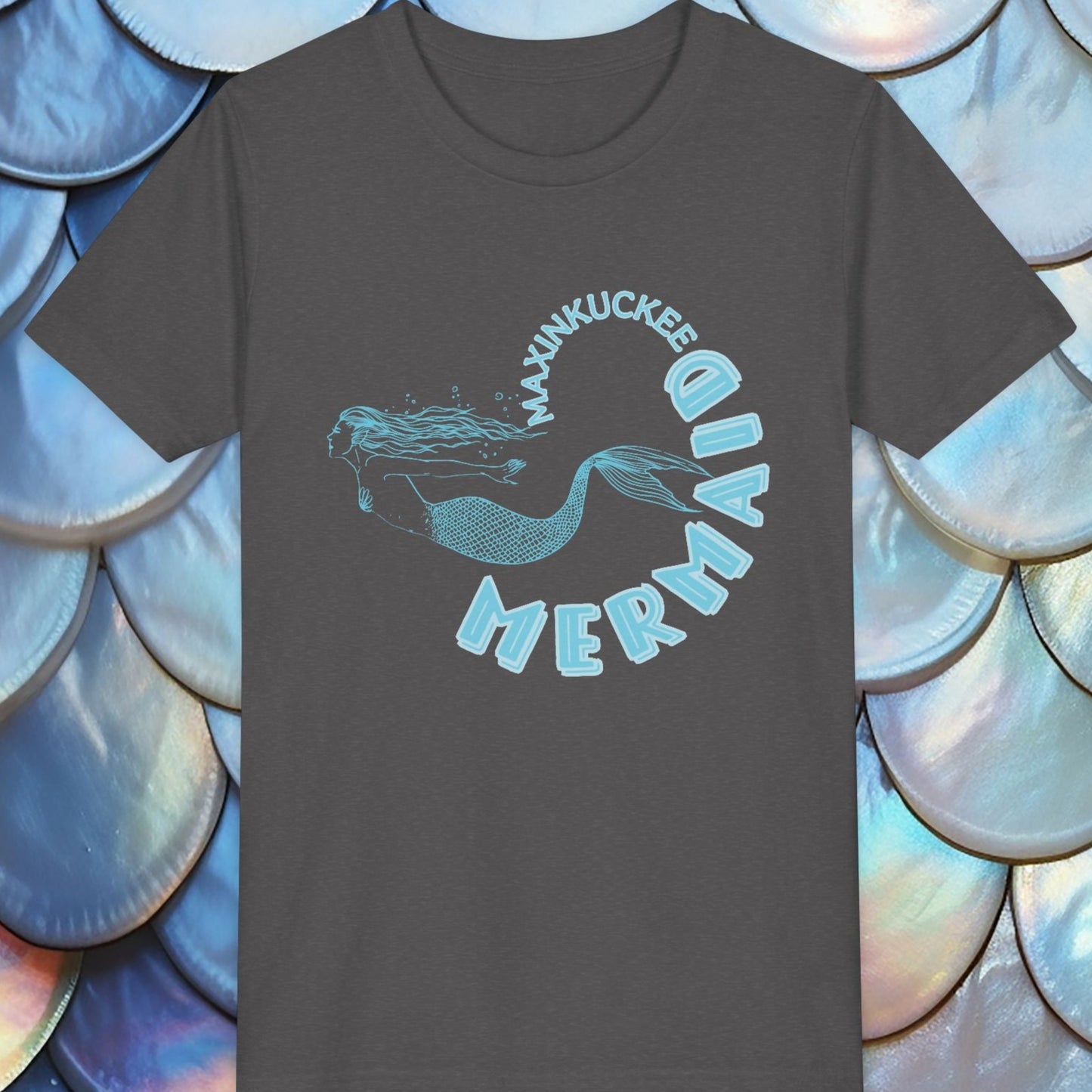  t-shirt with 'Maxinkuckee Mermaid' design on a background of blue and silver fish scales.