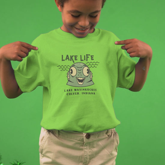 video of a kid in a shirt with a graphic of a water creature and text Lake Life Lake Maxinkuckee Culver Indiana