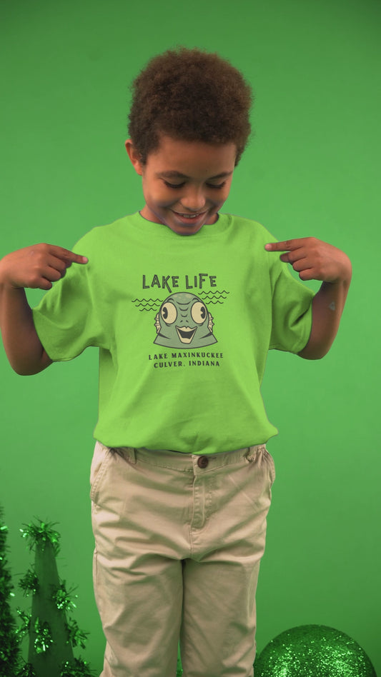 video of a kid in a shirt with a graphic of a water creature and text Lake Life Lake Maxinkuckee Culver Indiana